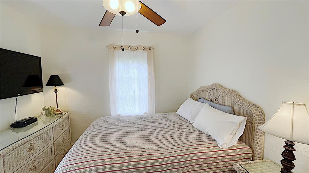 342 Southwest 2nd Avenue Dania Beach, FL 33004 - Photo 26 of 27 a bedroom with a bed and a flat screen tv