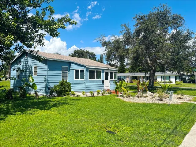 a front view of house with yard and outdoor seating