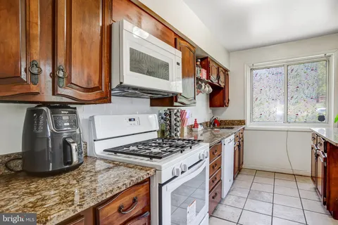 a kitchen with a stove a sink and a microwave