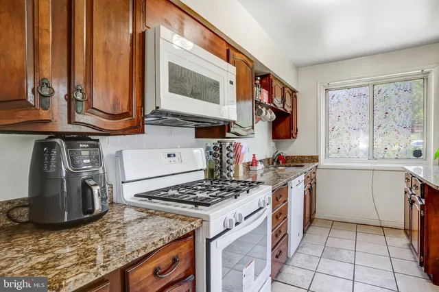 a kitchen with a stove a sink and a microwave