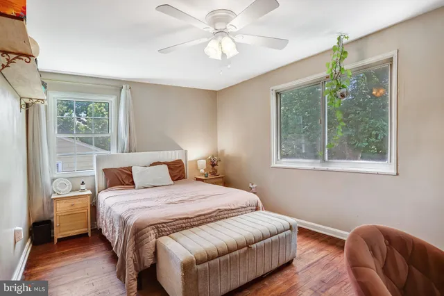 a bedroom with a bed chandelier and a window