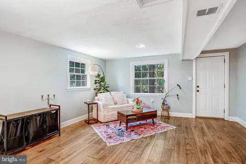 a living room with furniture and wooden floor