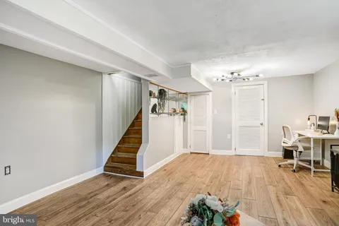 a view of a room with wooden floor and stairs
