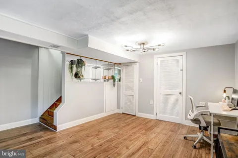 a view of a livingroom with a dinning area hardwood floor and a ceiling fan
