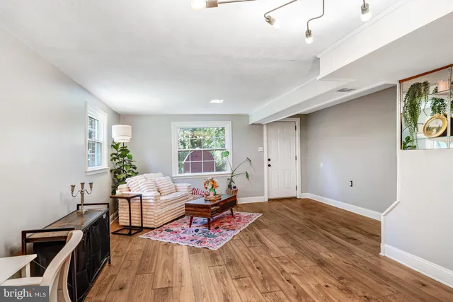 a living room with furniture and wooden floor
