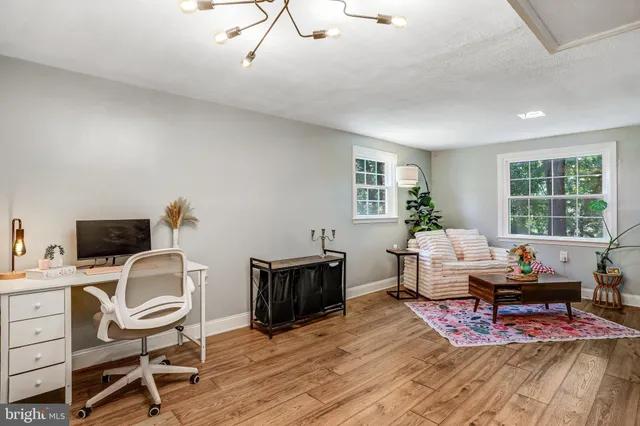 a workspace with furniture hardwood and a window