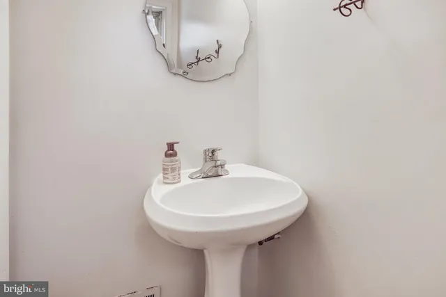 a bathroom with a sink a mirror and vanity