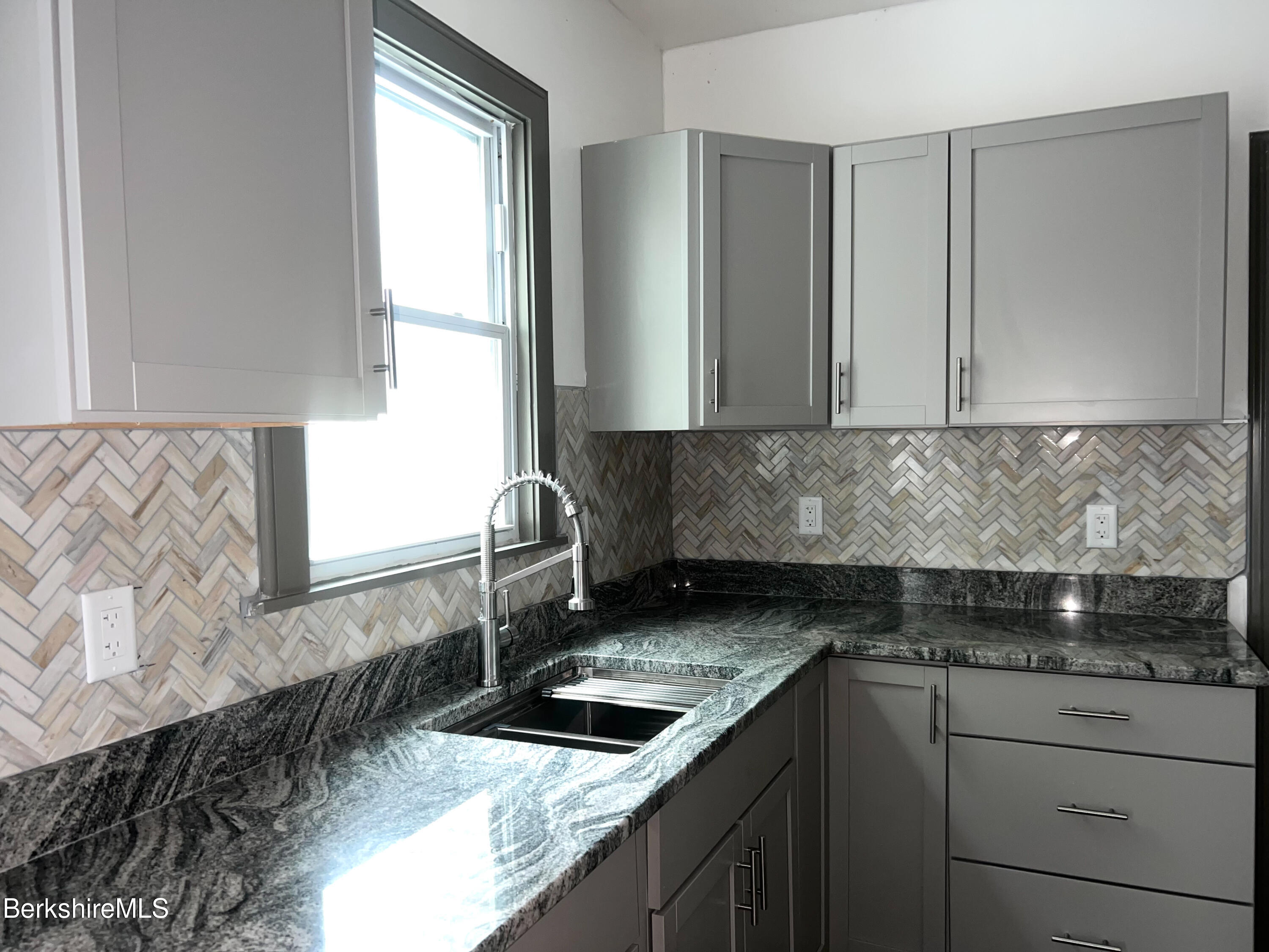 33-35 Hall Street North Adams, MA 01247 - Photo 11 of 44 a kitchen with granite countertop a sink and a stove