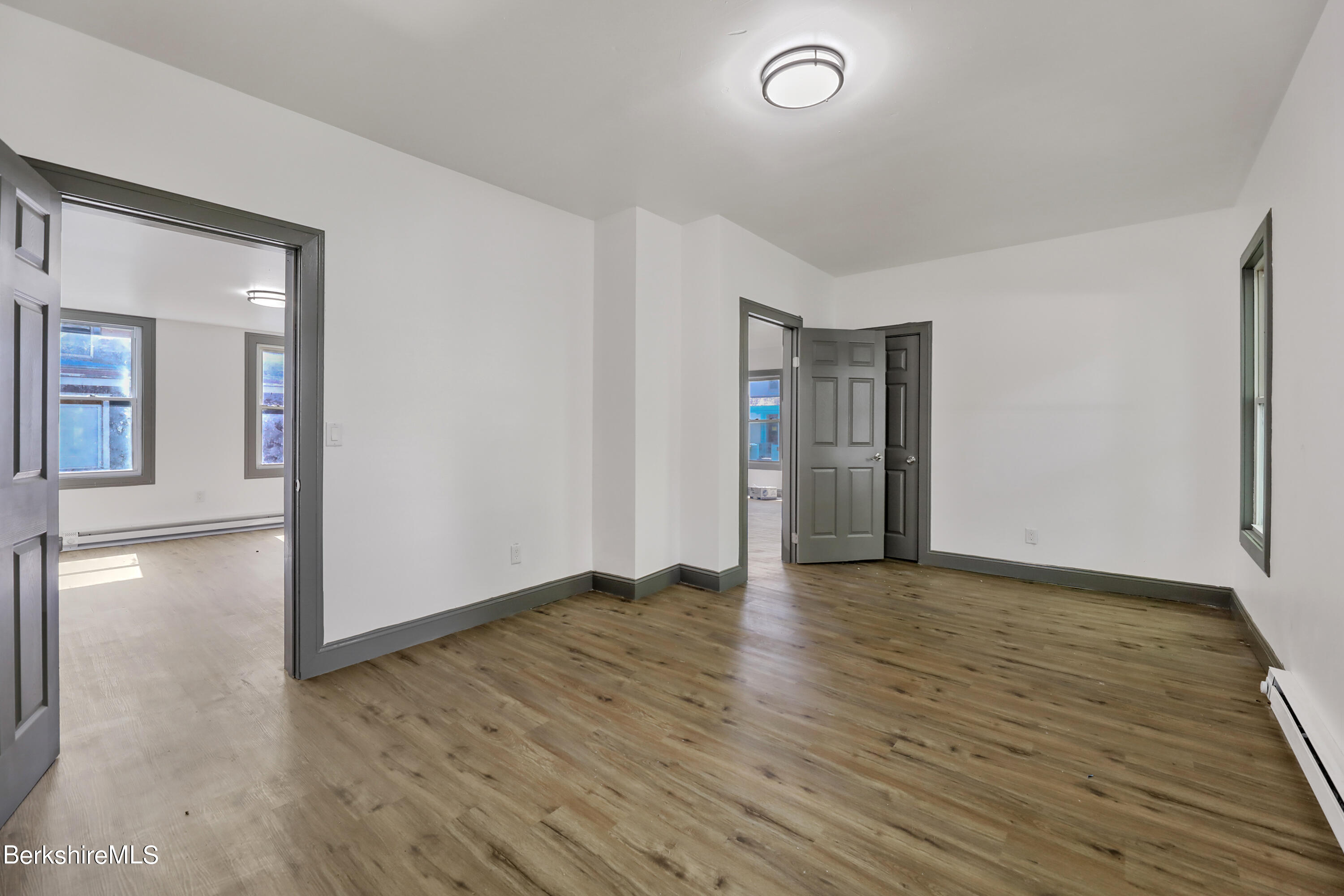 33-35 Hall Street North Adams, MA 01247 - Photo 16 of 44 an empty room with wooden floor and windows