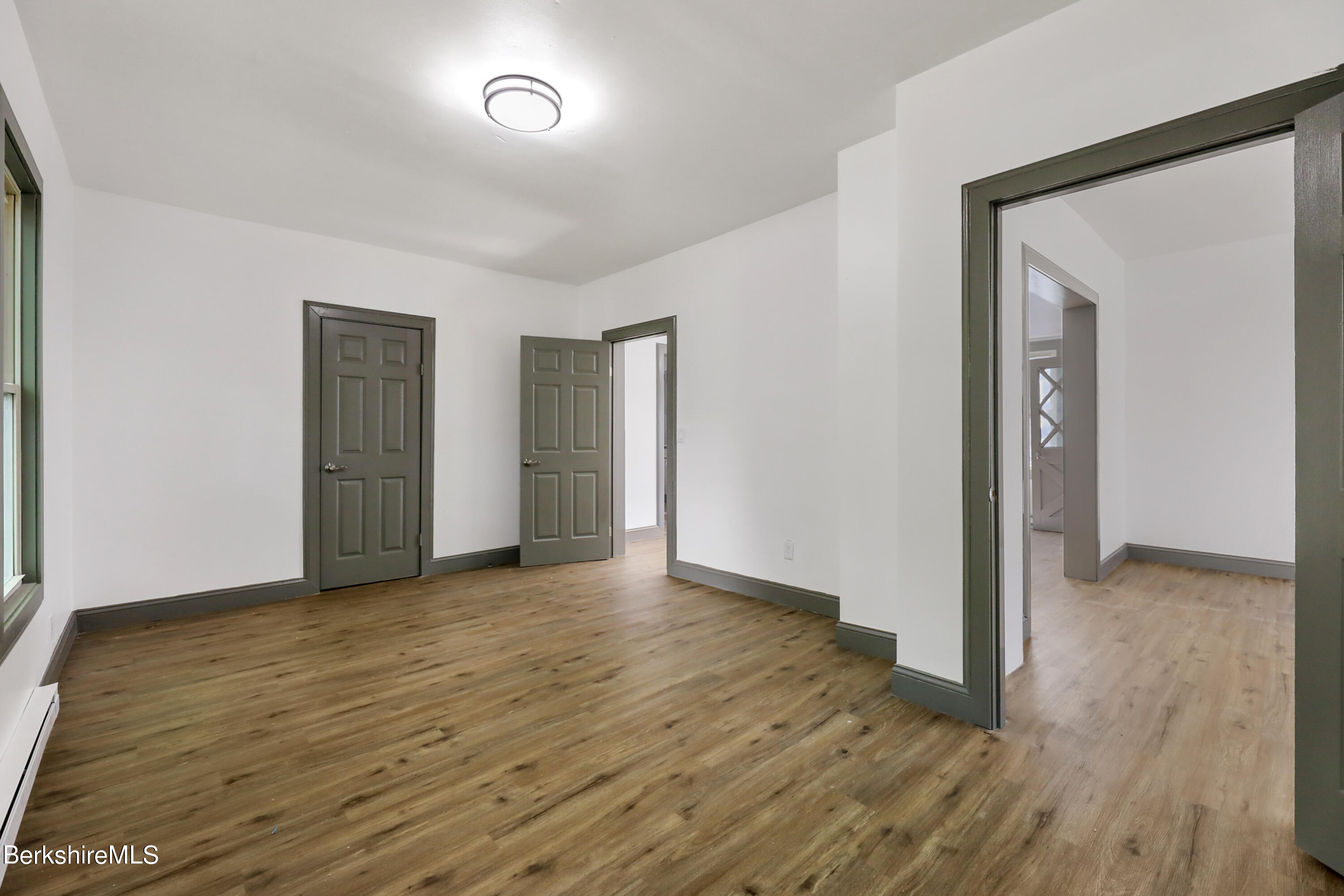 33-35 Hall Street North Adams, MA 01247 - Photo 17 of 44 an empty room with wooden floor and closet