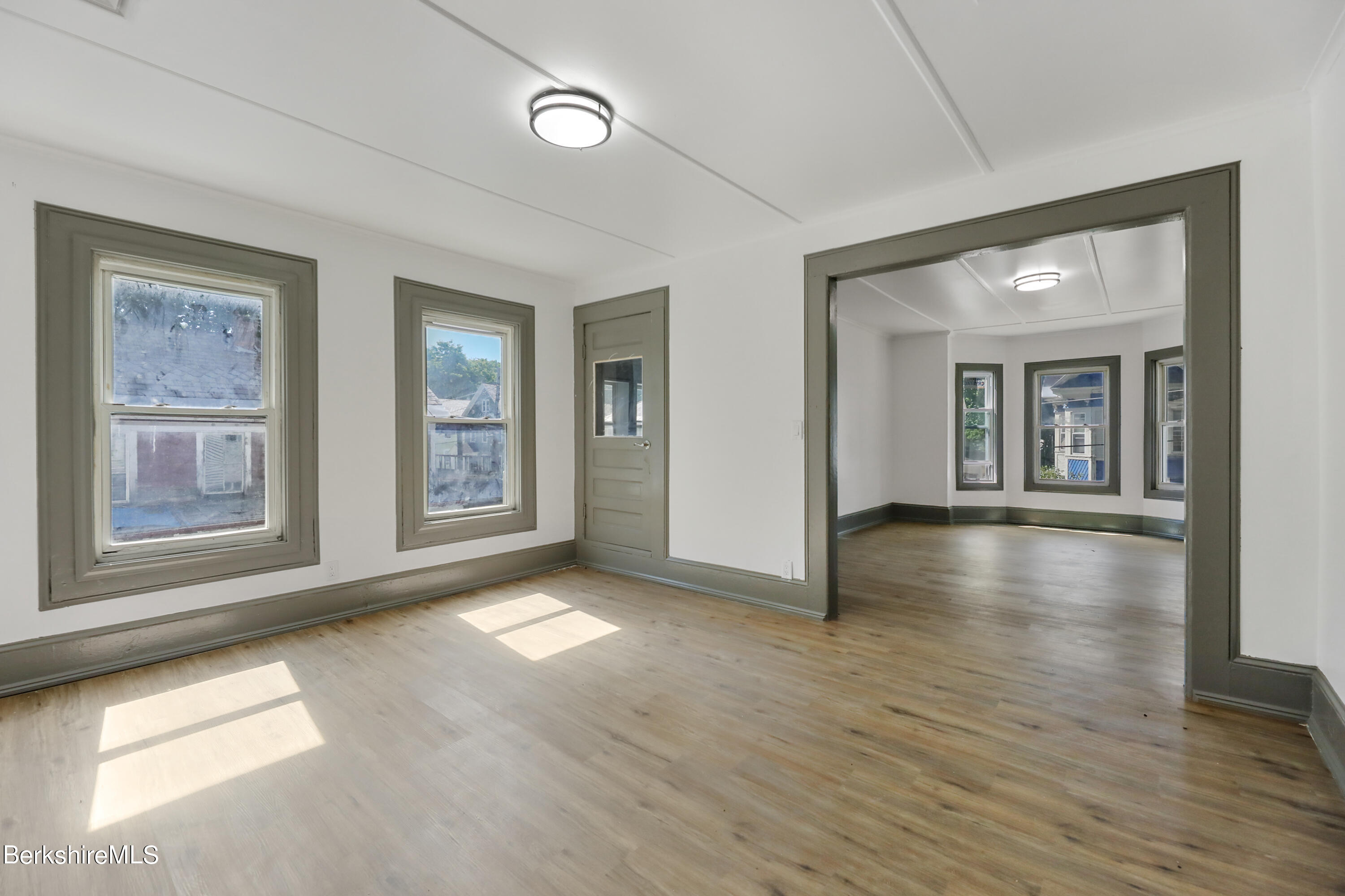 33-35 Hall Street North Adams, MA 01247 - Photo 25 of 44 an empty room with wooden floor and windows