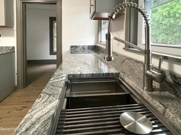 a kitchen with stainless steel appliances granite countertop a stove and a sink