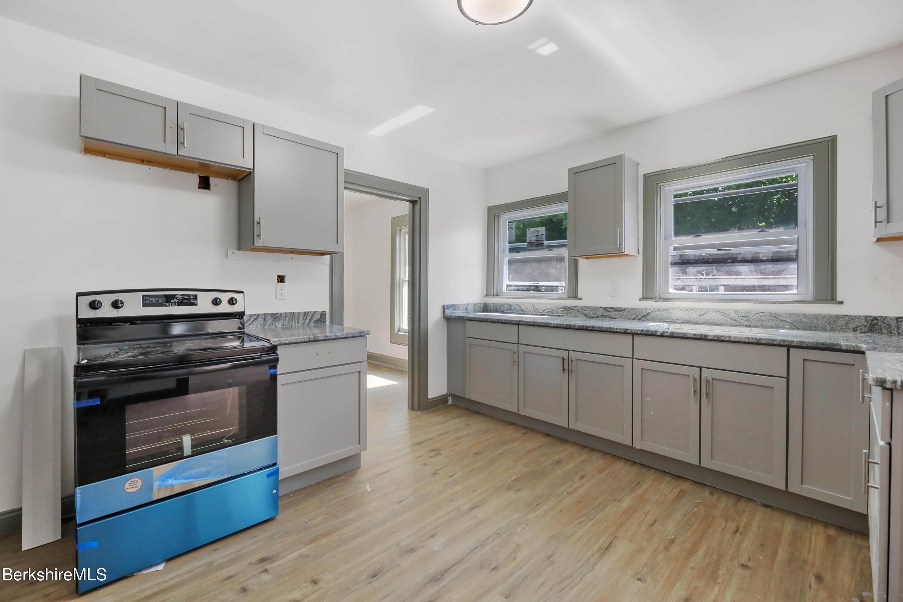 33-35 Hall Street North Adams, MA 01247 - Photo 28 of 44 a kitchen with stainless steel appliances granite countertop a stove and a sink
