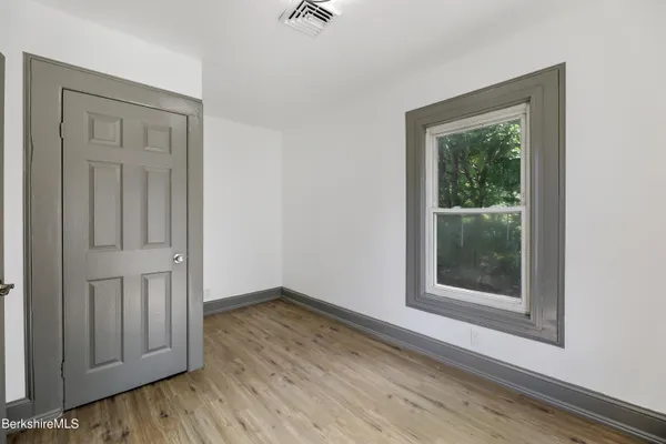 wooden floor in a hall with an empty room and wooden floor