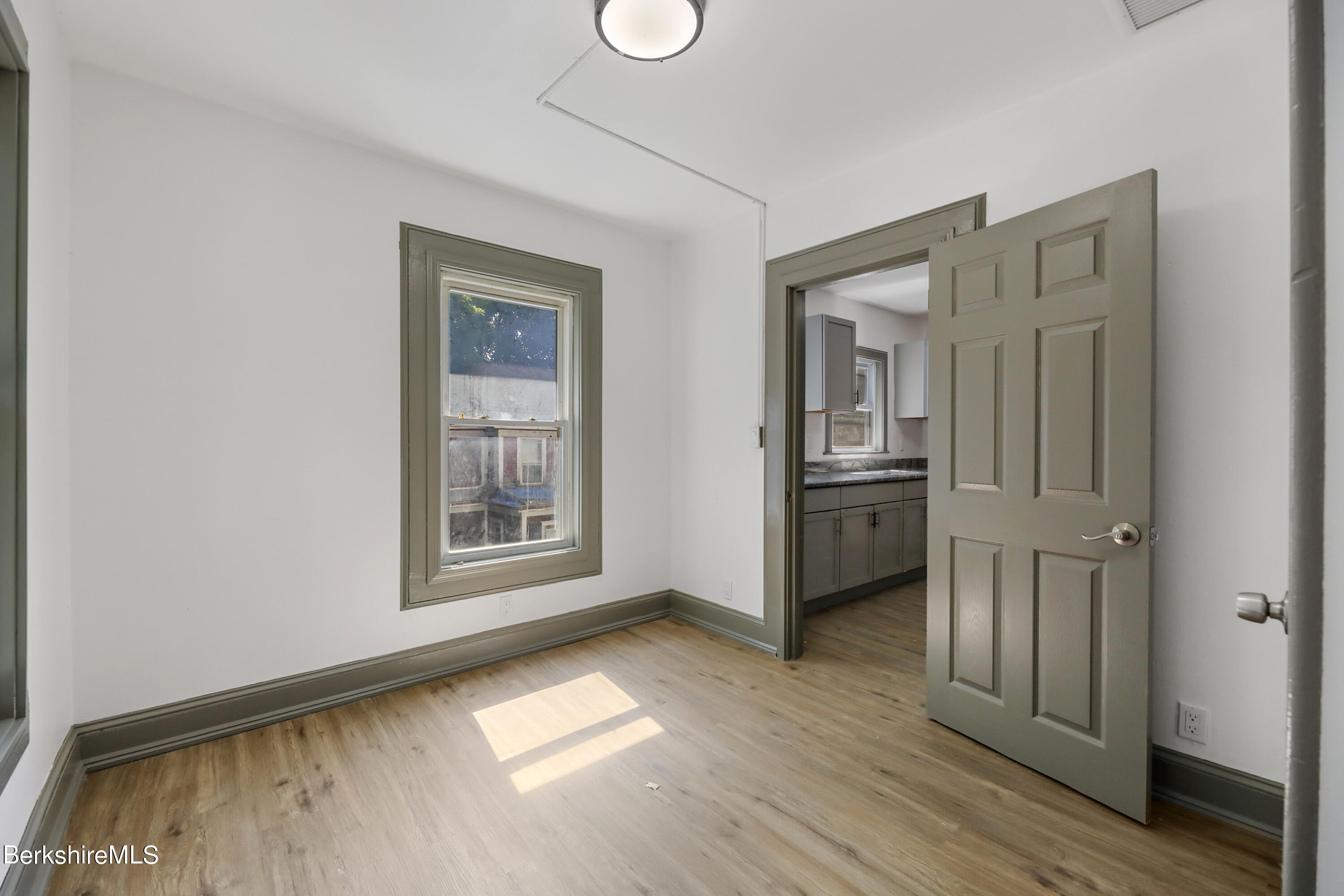 33-35 Hall Street North Adams, MA 01247 - Photo 35 of 44 a view of a kitchen with an empty room and wooden floor