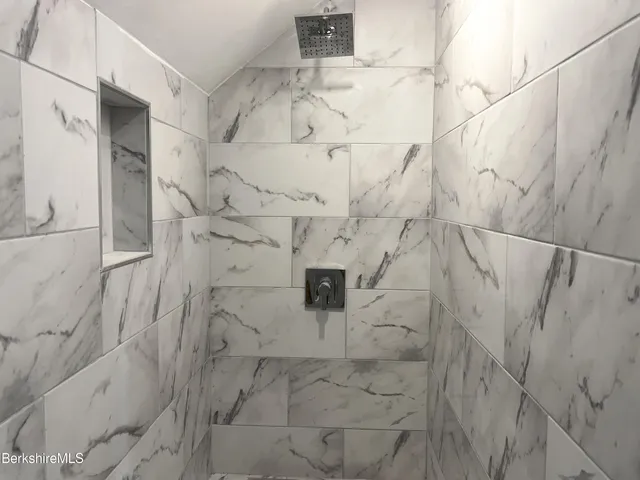 a bathroom with a sink toilet and mirror