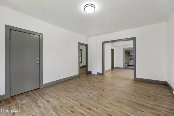 an empty room with wooden floor and closet