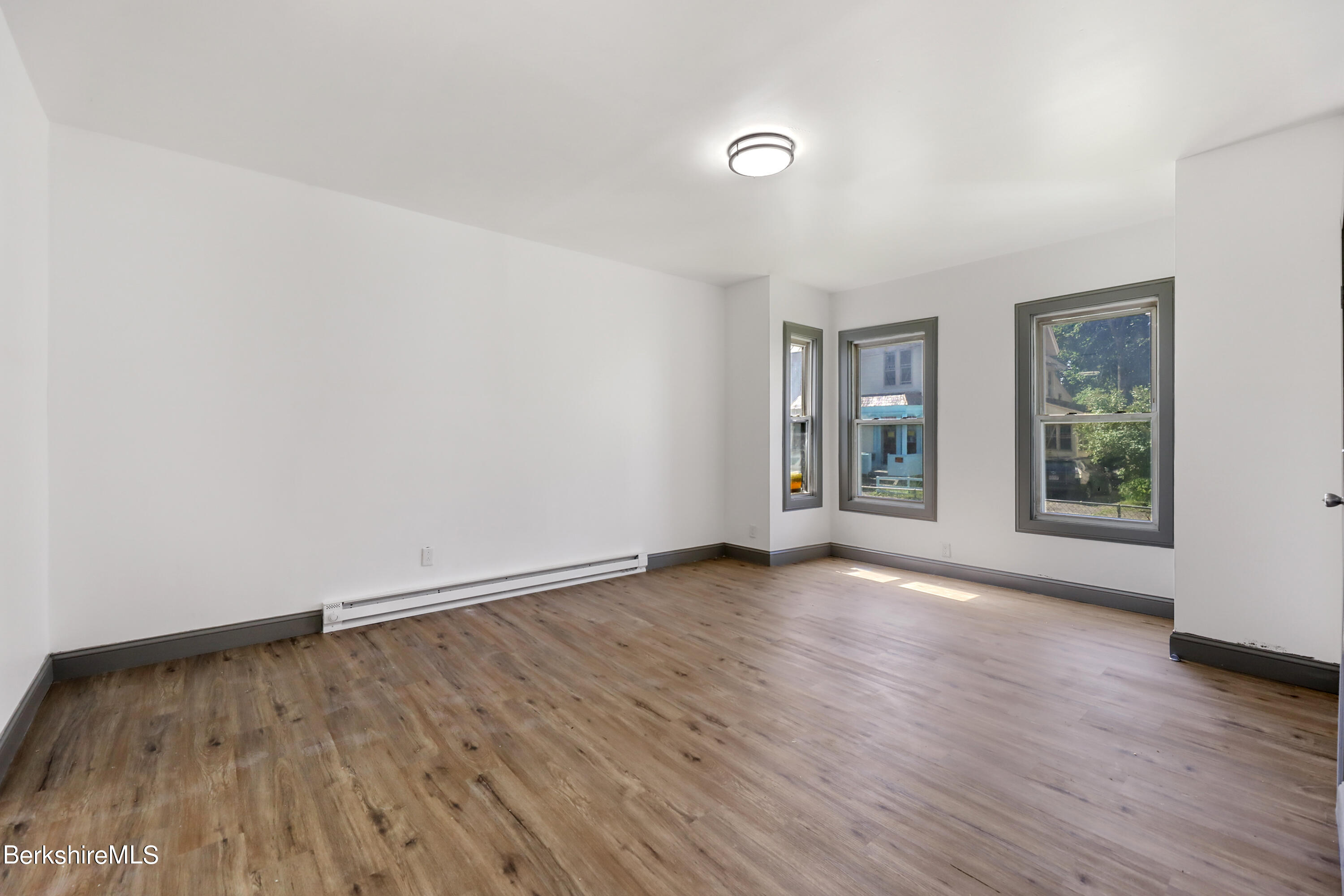 33-35 Hall Street North Adams, MA 01247 - Photo 6 of 44 an empty room with wooden floor and windows