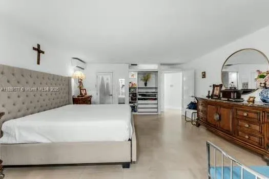 a spacious bedroom with a bed a dresser and mirror