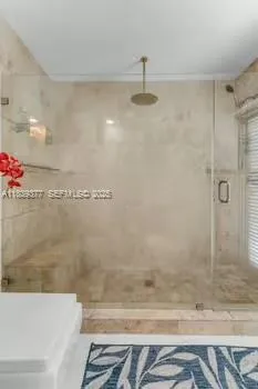 a bathroom with a bathtub and a shower