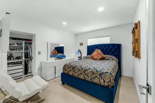 a bedroom with a large bed and a couch