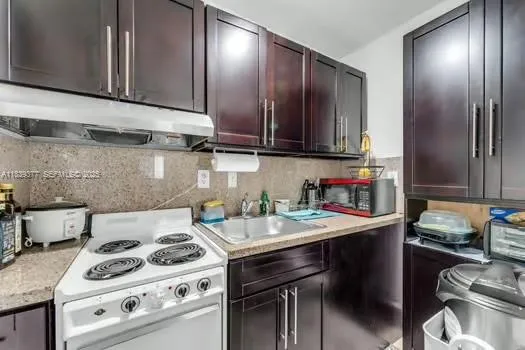 a kitchen with a stove and a sink