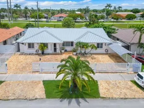 an aerial view of a house with garden space and lake view