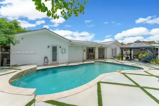 a view of a house with swimming pool and a yard