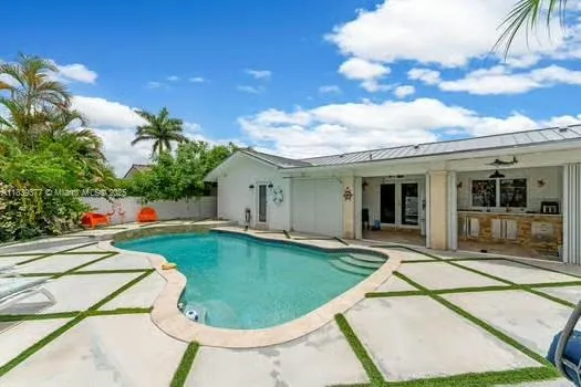 a view of a white house with a swimming pool