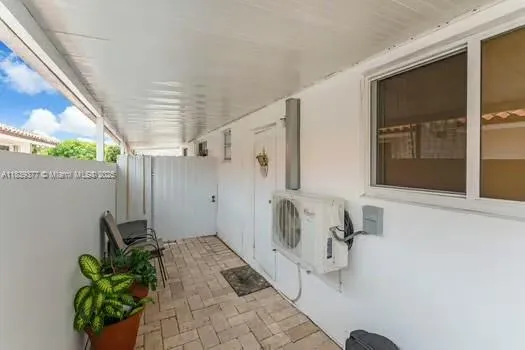 a bathroom with a tub shower and mirror