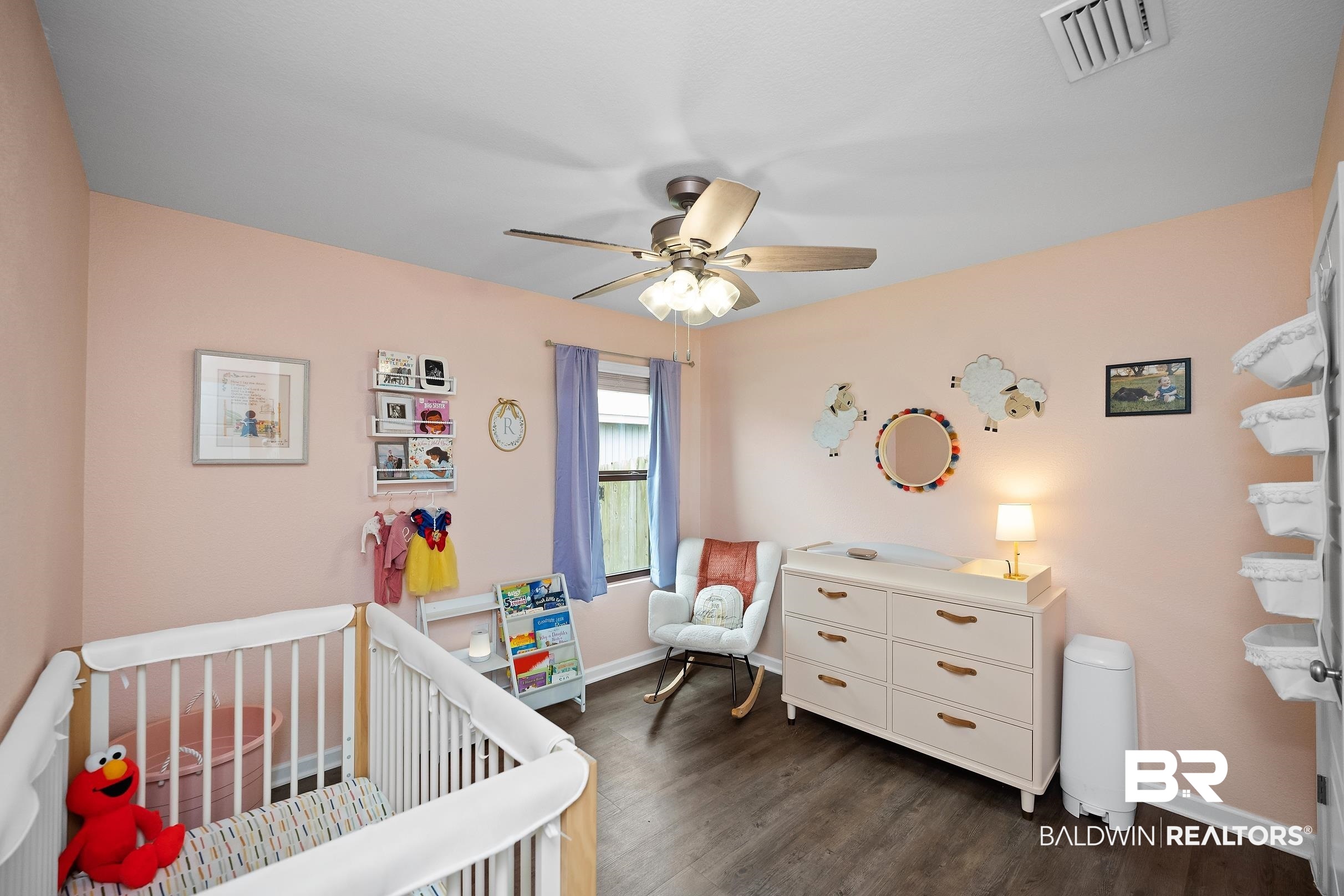 32030 Terranova Loop Lillian, AL 36549 - Photo 15 of 30 Spacious interior room featuring wood-finish flooring, a ceiling fan with integrated lighting, and a window with light-filtering curtains
