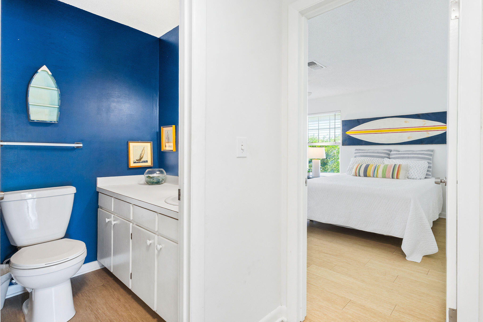 81 San Juan Avenue Santa Rosa Beach, FL 32459 - Photo 13 of 33 a bathroom with a toilet sink vanity and mirror