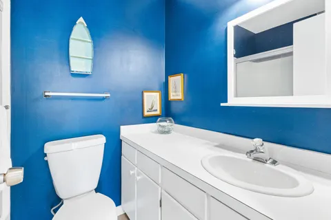 a bathroom with a toilet sink and mirror