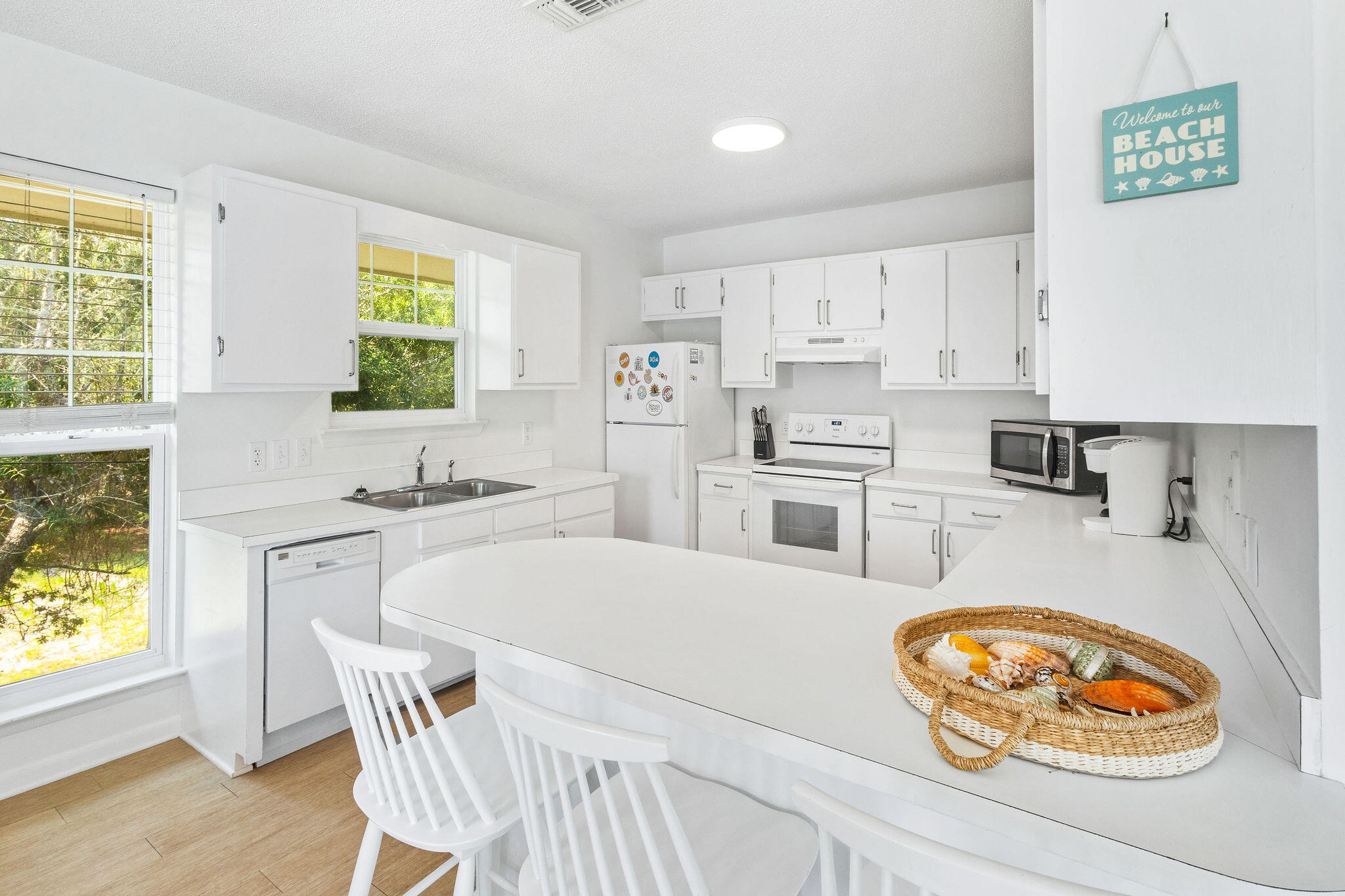 81 San Juan Avenue Santa Rosa Beach, FL 32459 - Photo 6 of 33 a kitchen with stainless steel appliances granite countertop a sink a stove a refrigerator cabinets and a window