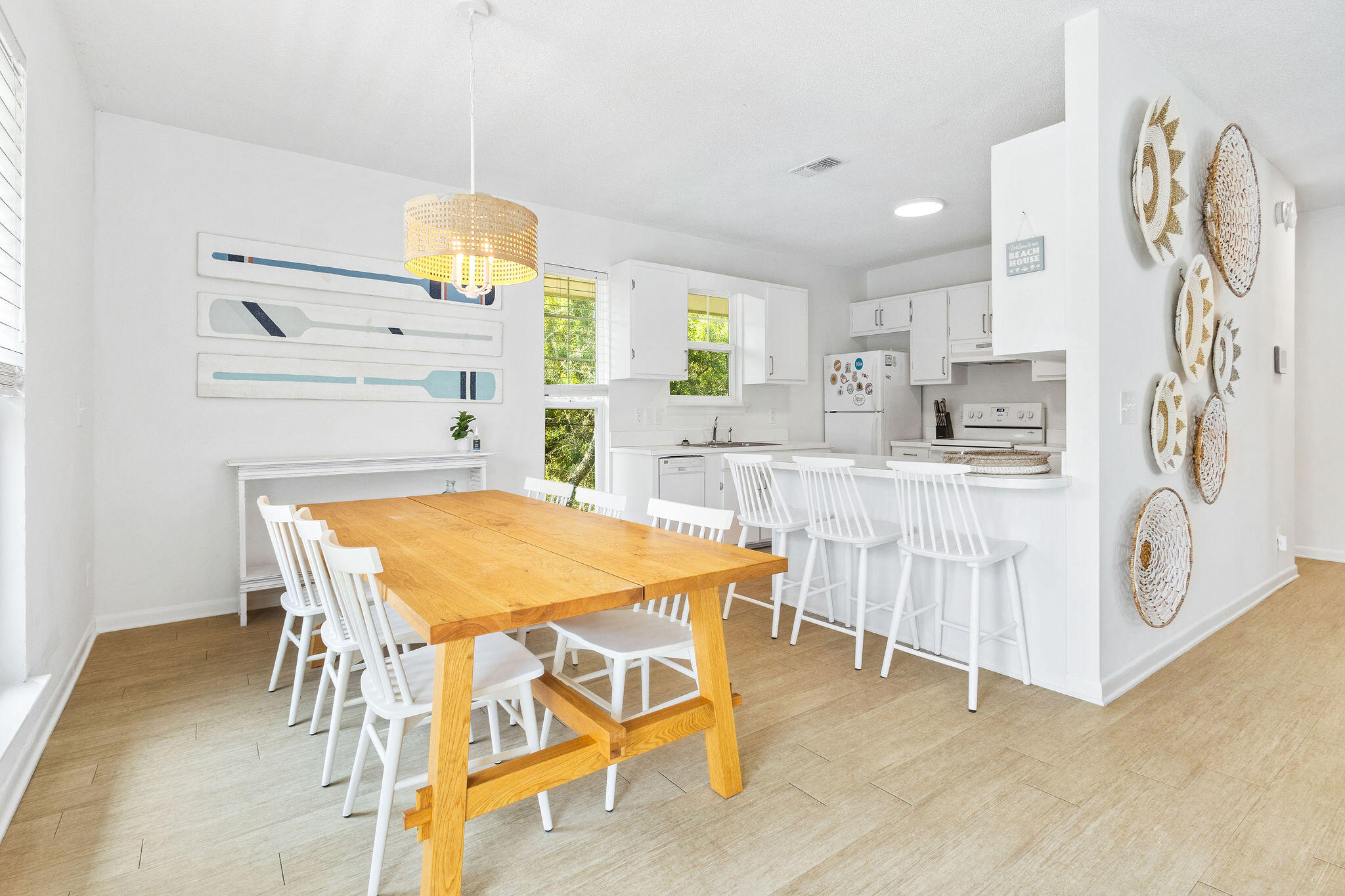 81 San Juan Avenue Santa Rosa Beach, FL 32459 - Photo 10 of 33 a kitchen with stainless steel appliances kitchen island granite countertop a table and chairs in it
