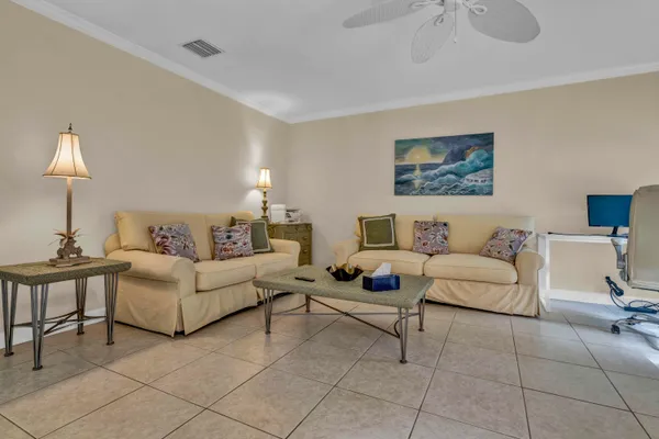 a living room with furniture and a lamp