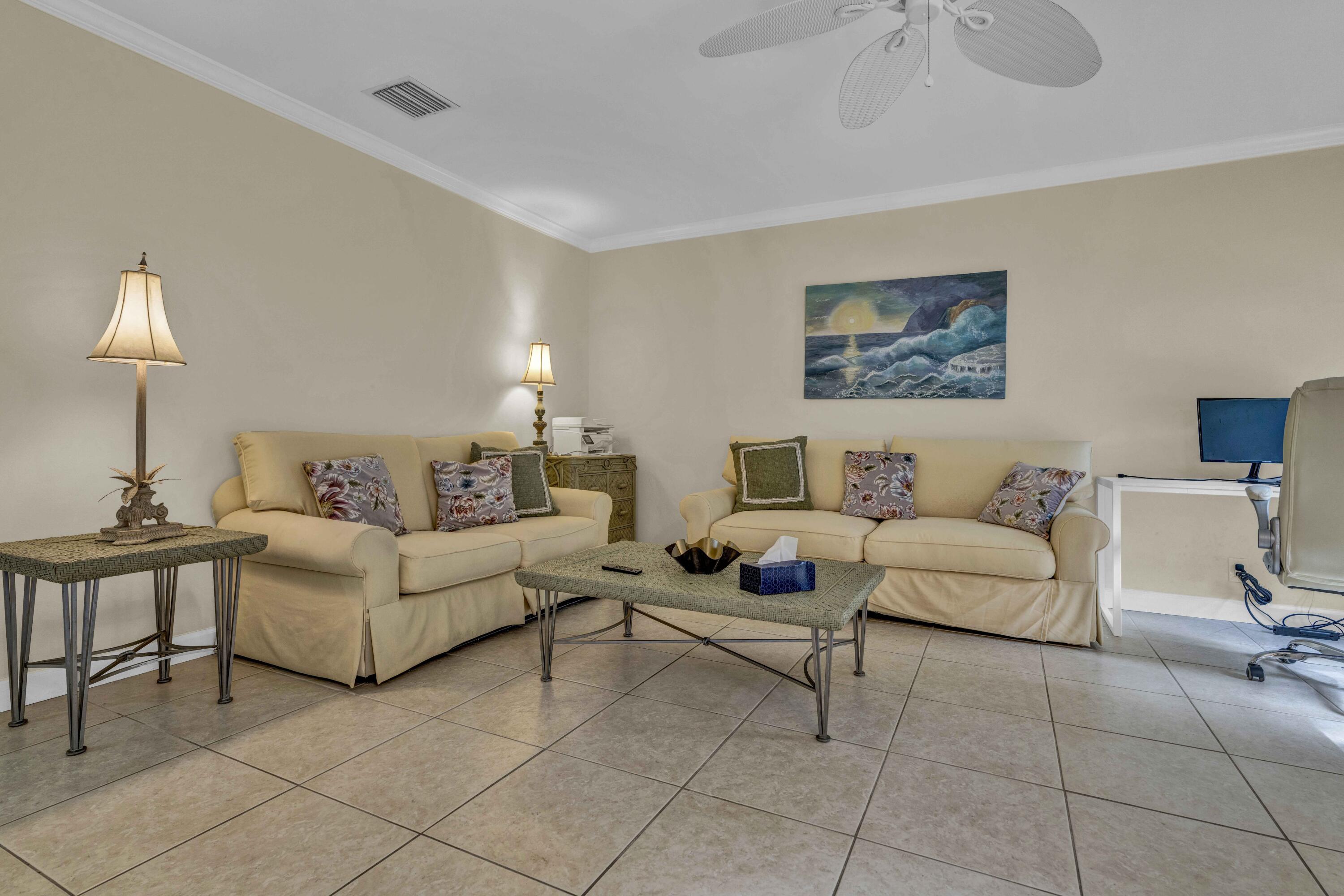 22323 Martella Avenue Boca Raton, FL 33433 - Photo 11 of 21 a living room with furniture and a lamp