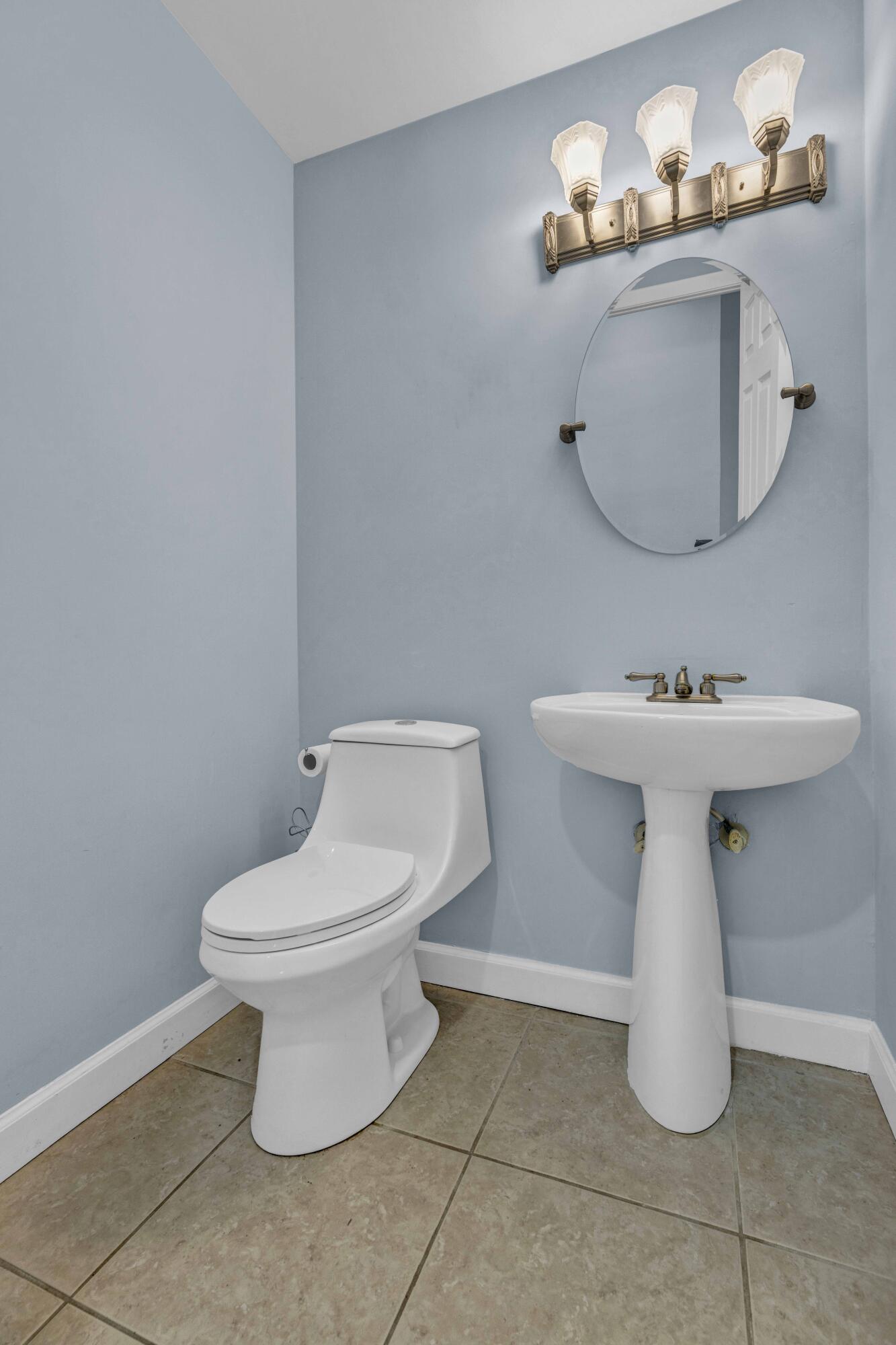 22323 Martella Avenue Boca Raton, FL 33433 - Photo 12 of 21 a bathroom with a toilet sink and mirror