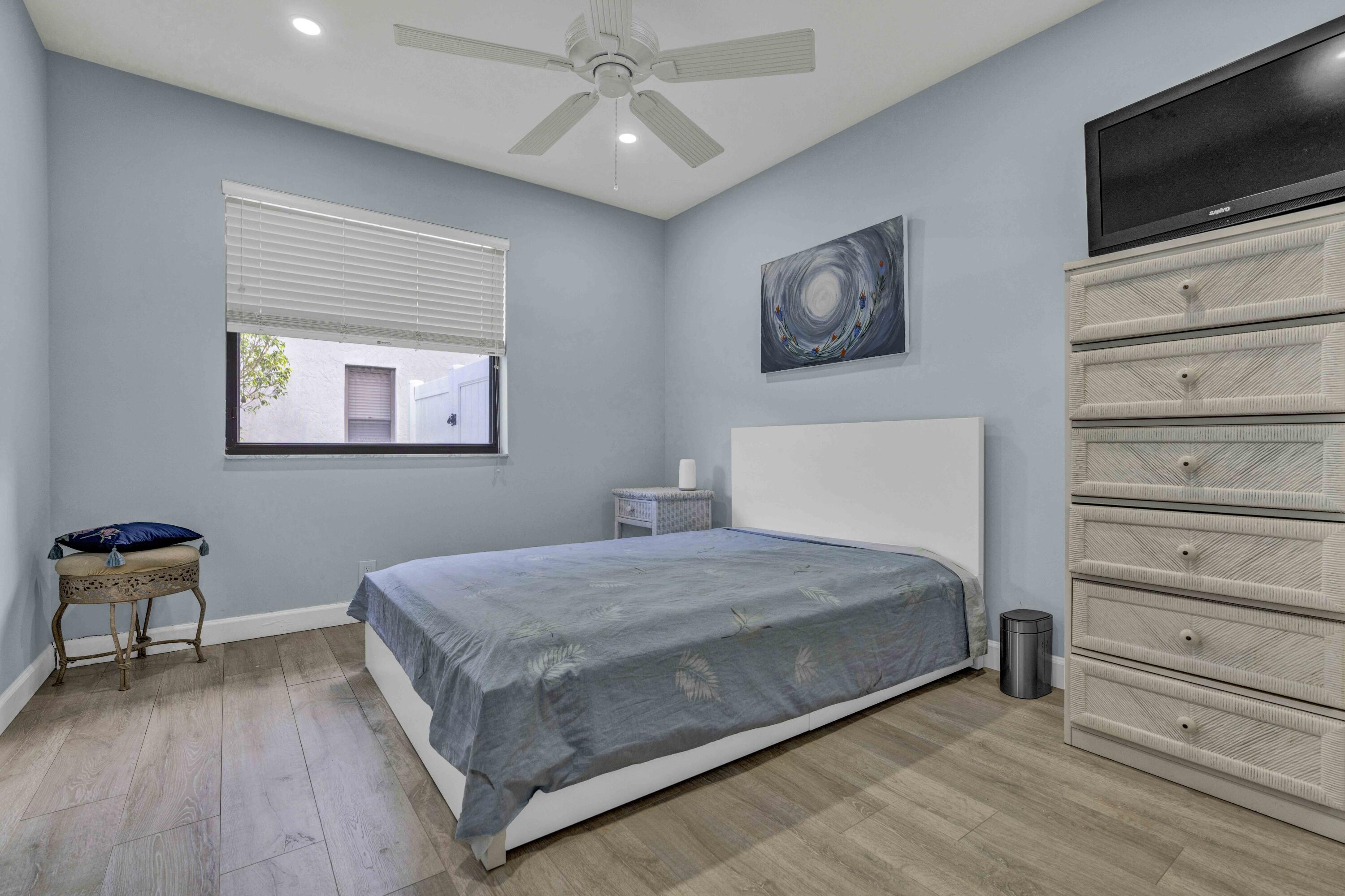 22323 Martella Avenue Boca Raton, FL 33433 - Photo 15 of 21 a bedroom with a bed and a flat screen tv