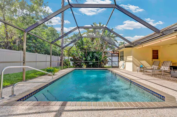 a view of a backyard with sitting area