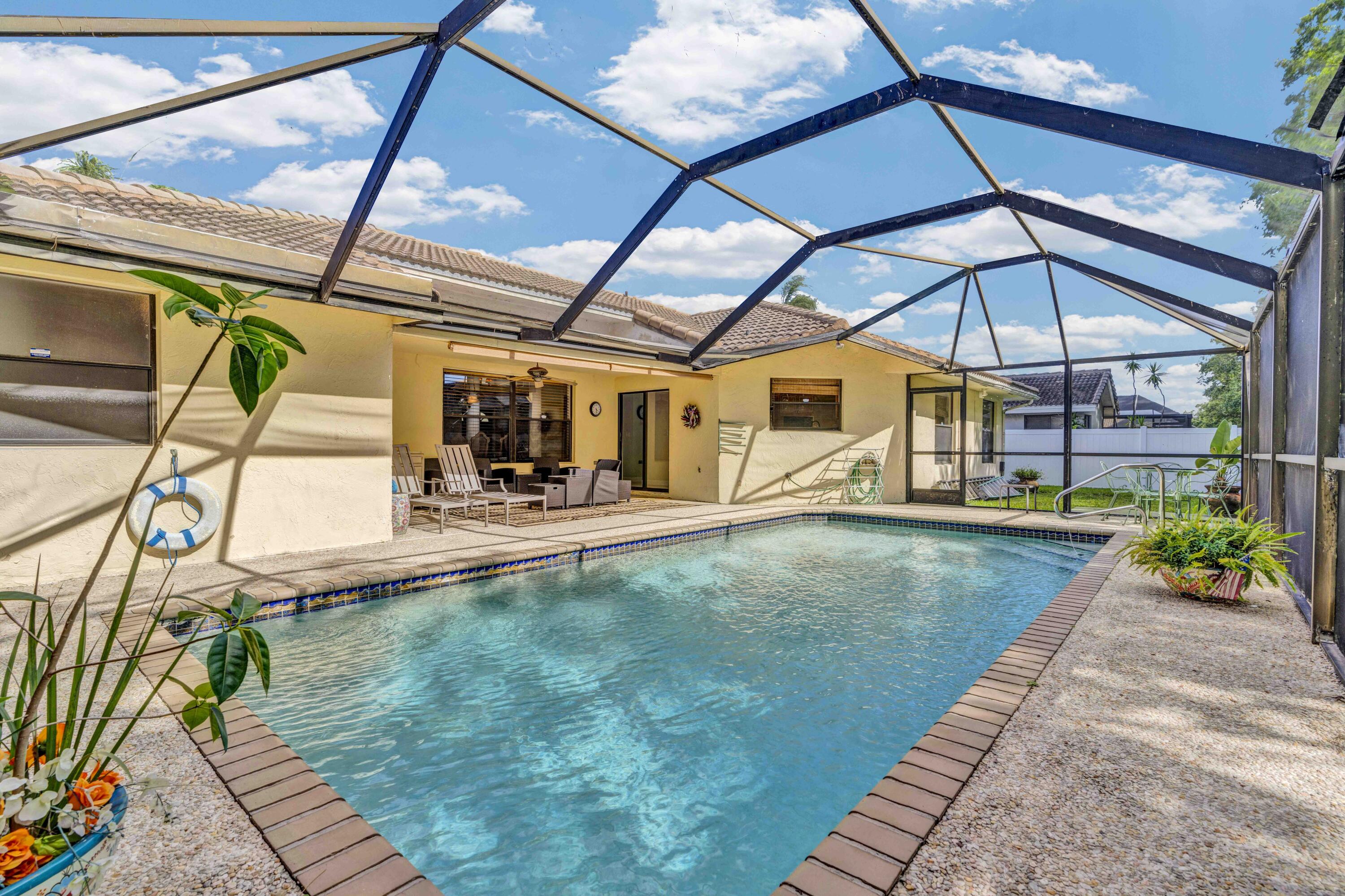 22323 Martella Avenue Boca Raton, FL 33433 - Photo 19 of 21 a view of a swimming pool with a patio