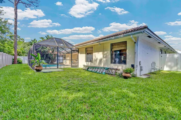 a view of a house with backyard and porch