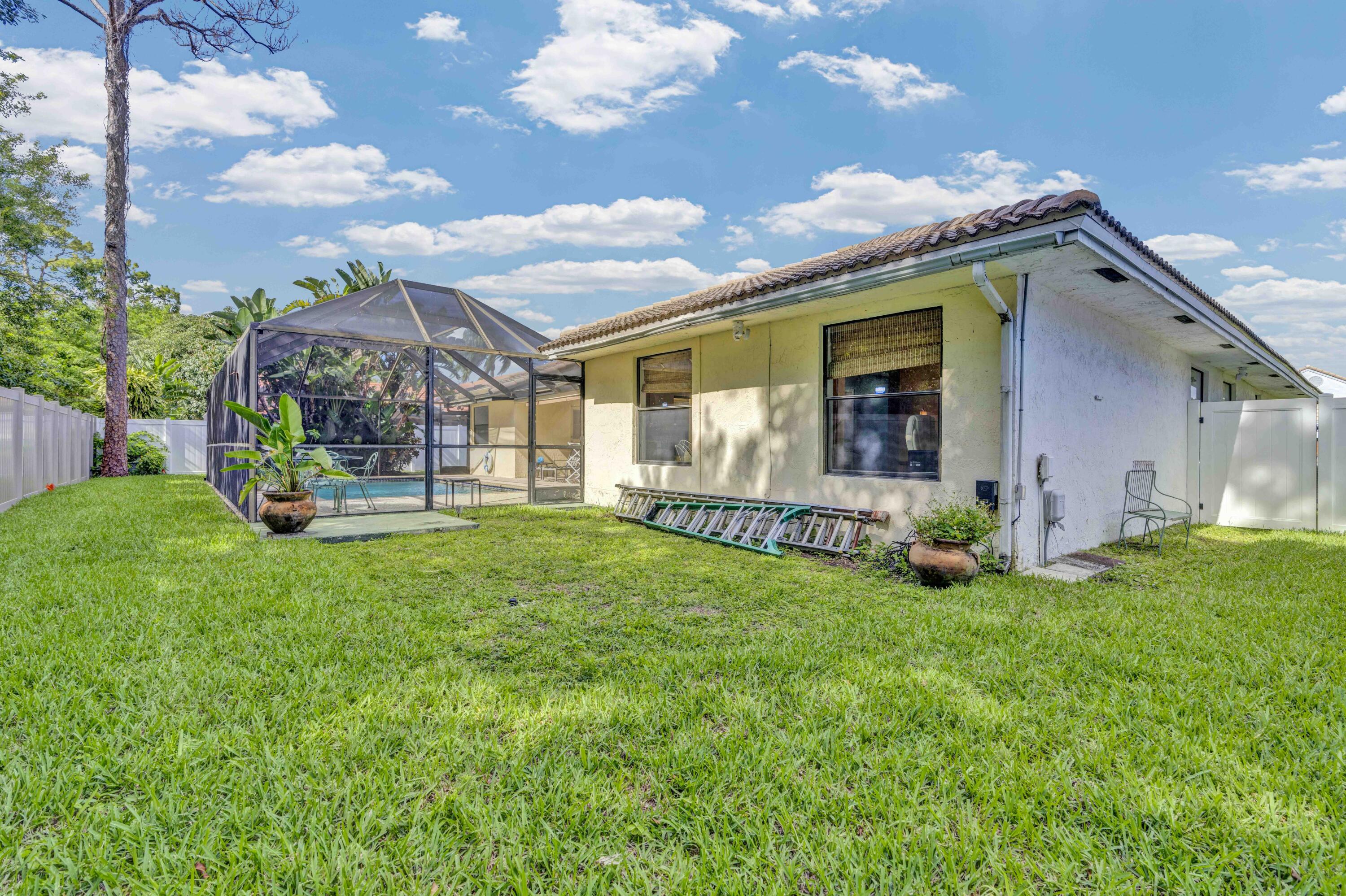 22323 Martella Avenue Boca Raton, FL 33433 - Photo 20 of 21 a view of a house with backyard and porch