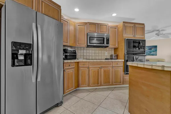 a kitchen with stainless steel appliances a refrigerator stove microwave and sink