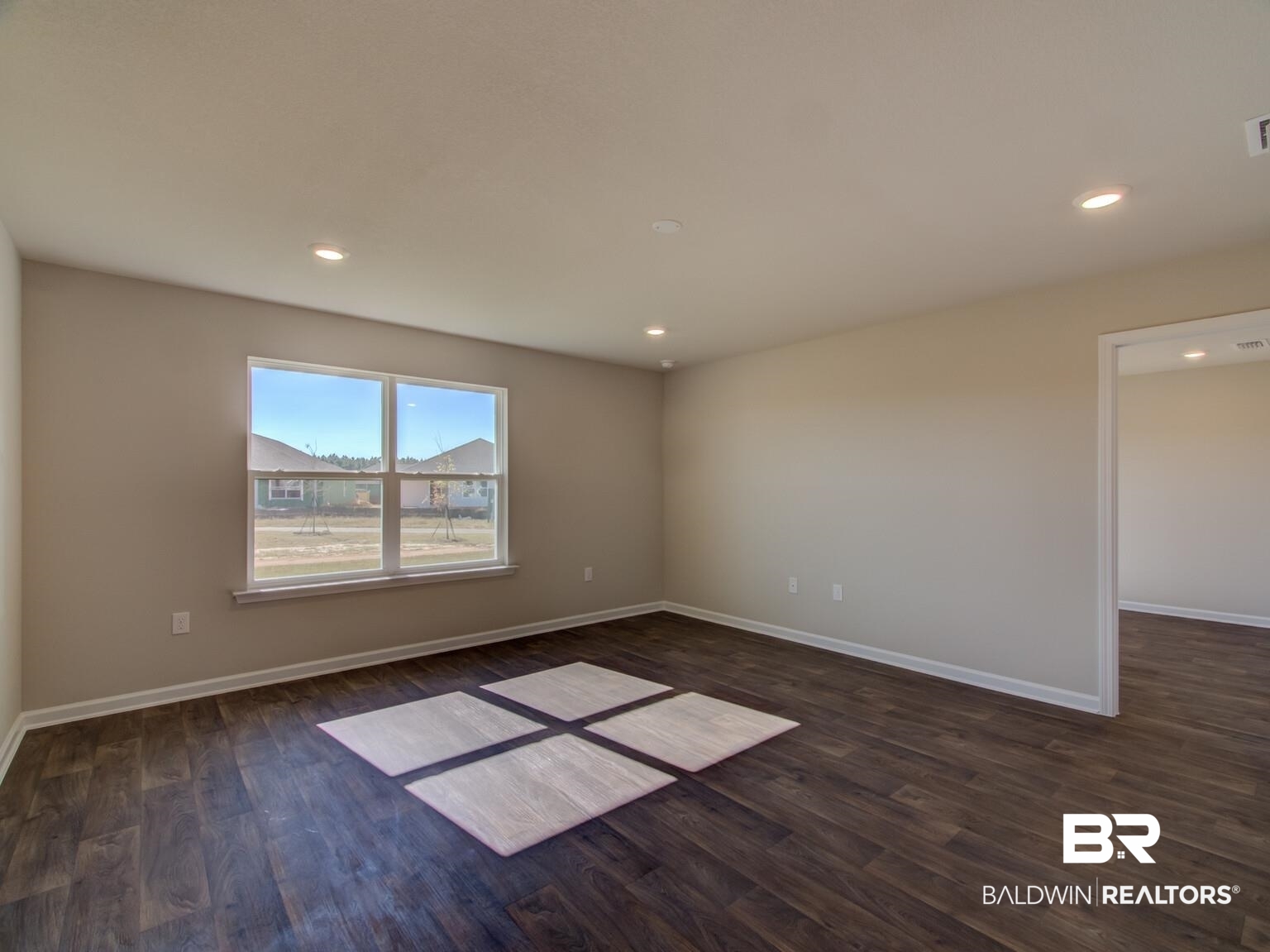 23953 Citation Loop Daphne, AL 36526 - Photo 7 of 49 Empty room featuring dark wood finished floors and recessed lighting