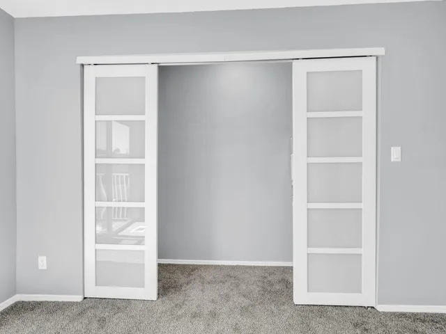 a view of an empty room with closet