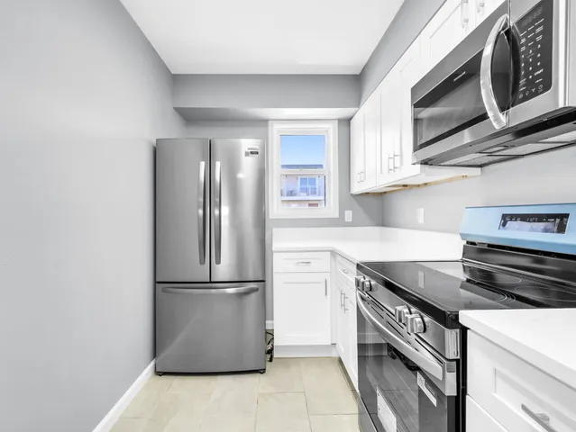 a kitchen with stainless steel appliances granite countertop a refrigerator stove and microwave
