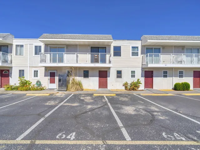 a front view of multiple houses with street