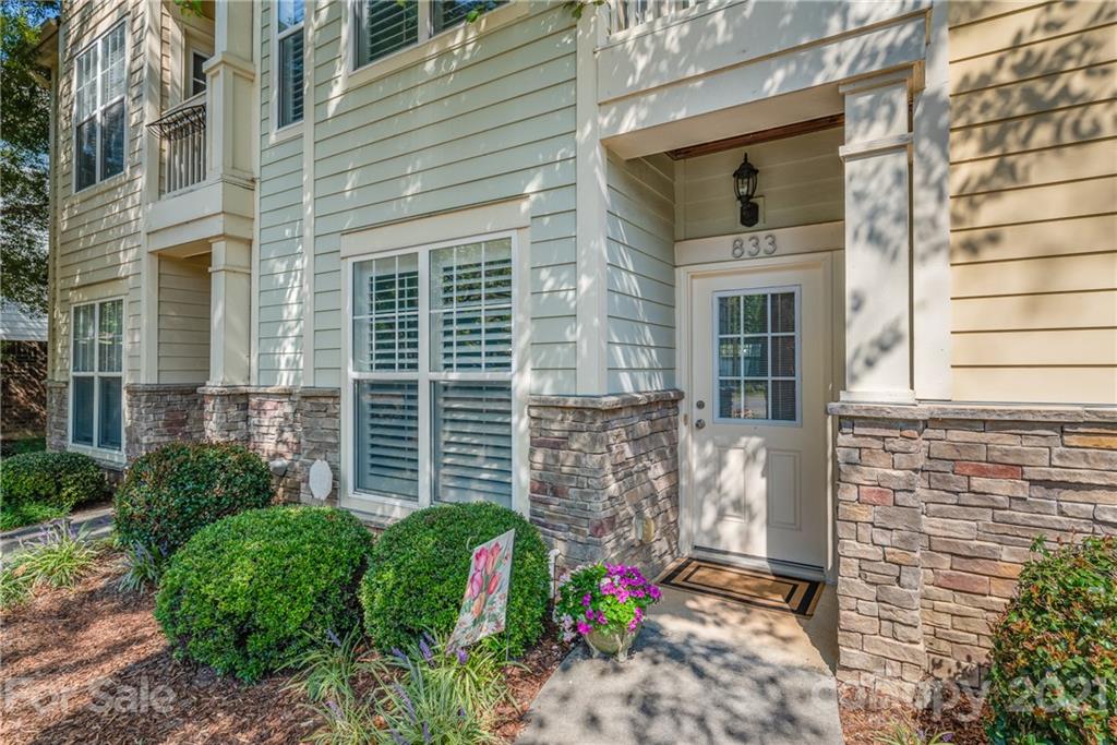 833 Millbrook Road, Unit 833 Charlotte, NC 28211 - Photo 2 of 23 a view of a door with a chair and potted plants
