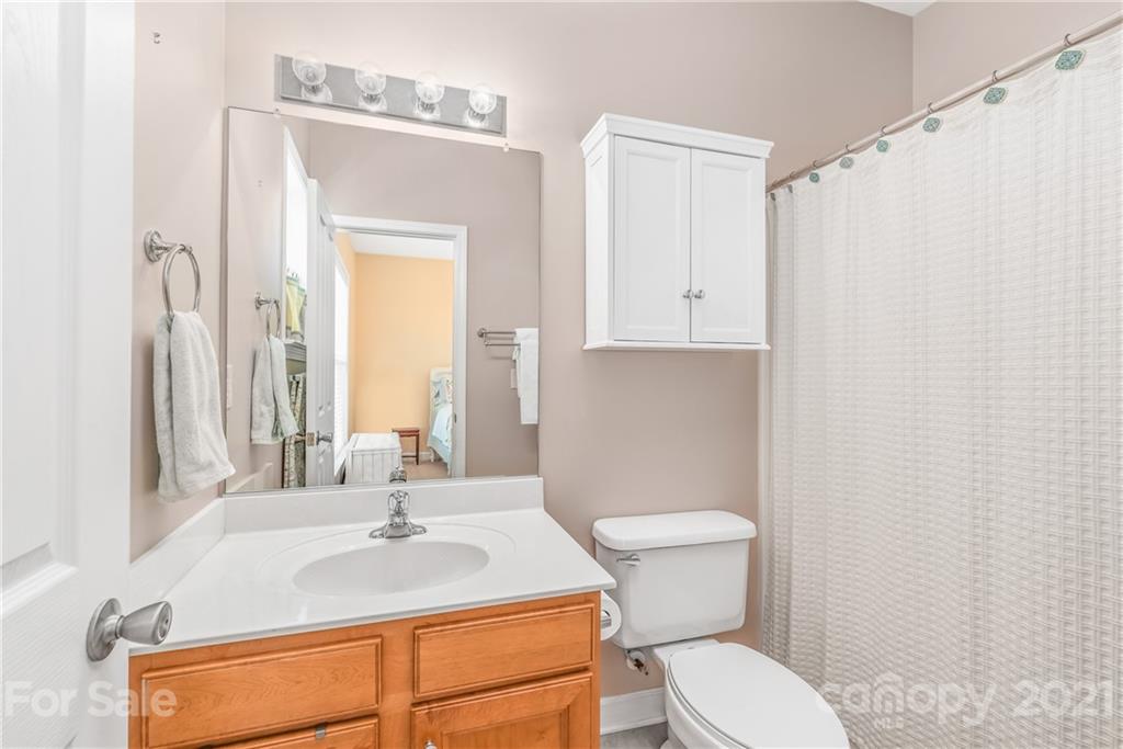 833 Millbrook Road, Unit 833 Charlotte, NC 28211 - Photo 18 of 23 a bathroom with a sink a toilet and a mirror